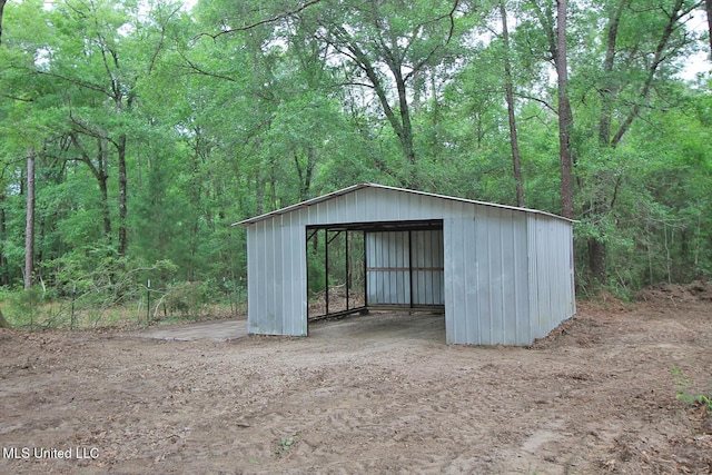 view of outdoor structure featuring an outdoor structure and a forest view