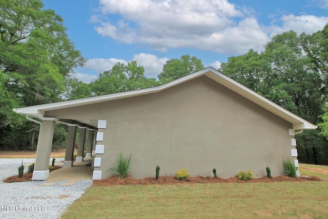 view of property exterior with a yard and stucco siding