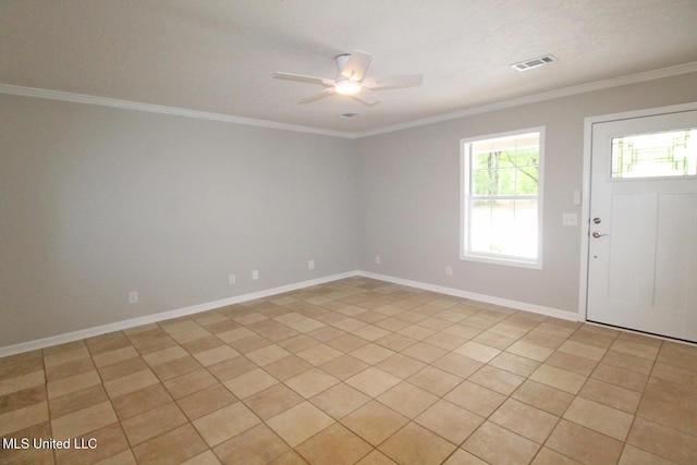 empty room with baseboards, ornamental molding, a ceiling fan, and visible vents