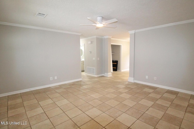 spare room with ornamental molding, a ceiling fan, and visible vents