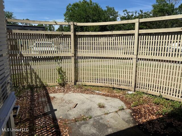 view of gate with a patio and fence