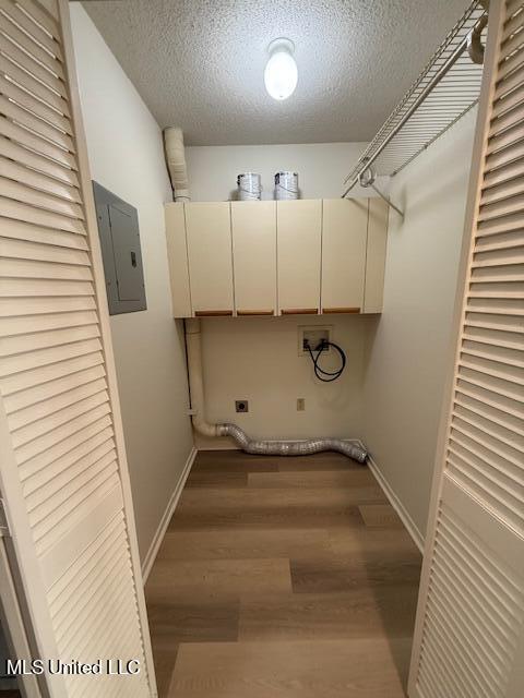 laundry area with washer hookup, electric panel, electric dryer hookup, a textured ceiling, and wood finished floors