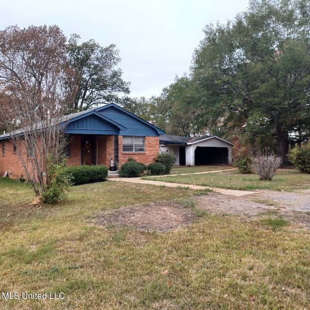 view of front of house with a front yard and a garage