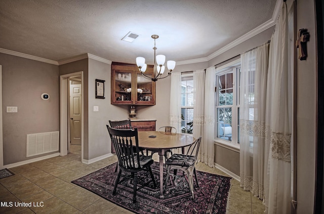 320 Woodhollow Cv, Brandon, MS 39047 - dining area with a chandelier, light tile patterned floors, a textured ceiling, and ornamental molding