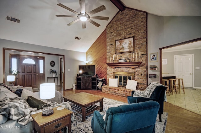 320 Woodhollow Cv, Brandon, MS 39047 - living area with high vaulted ceiling, ceiling fan, a fireplace, wood finished floors, and beamed ceiling