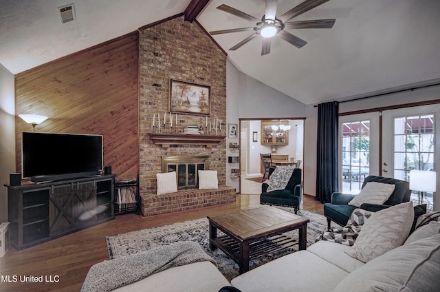 320 Woodhollow Cv, Brandon, MS 39047 - living area with high vaulted ceiling, wood finished floors, a ceiling fan, wood walls, and beam ceiling