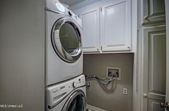 320 Woodhollow Cv, Brandon, MS 39047 - washroom with stacked washing machine and dryer, cabinet space, and crown molding