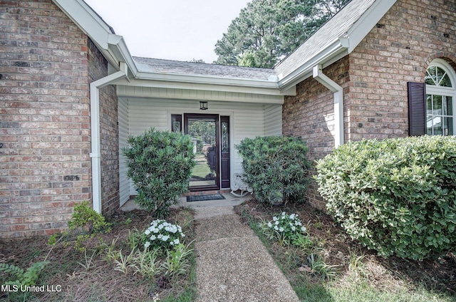 320 Woodhollow Cv, Brandon, MS 39047 - view of exterior entry featuring brick siding and roof with shingles