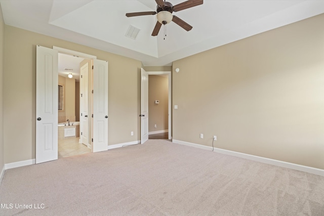 4913 Deer Run Rd, Olive Branch, MS 38654 - unfurnished bedroom with light colored carpet, baseboards, ensuite bathroom, a raised ceiling, and a ceiling fan