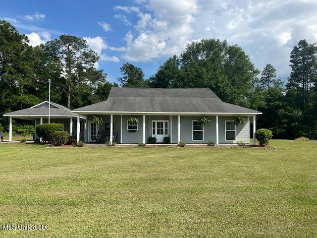 8100 Belle Etheridge Rd, Lucedale, MS 39452 - farmhouse-style home featuring covered porch and a front lawn