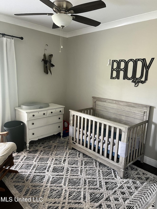 8100 Belle Etheridge Rd, Lucedale, MS 39452 - bedroom with a nursery area, a ceiling fan, and ornamental molding