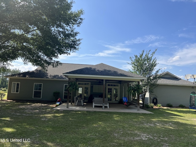 8100 Belle Etheridge Rd, Lucedale, MS 39452 - rear view of house featuring french doors, a patio area, a trampoline, a yard, and a shingled roof