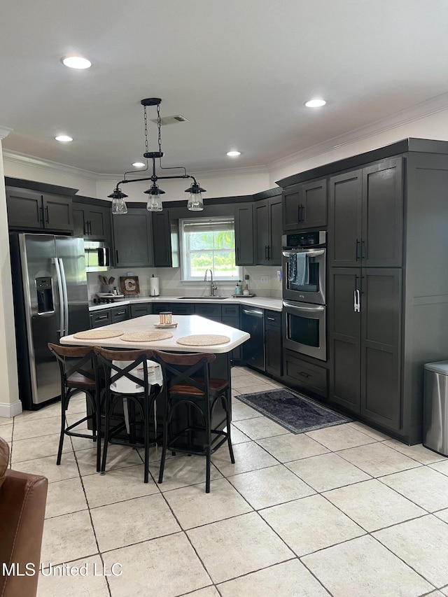 8100 Belle Etheridge Rd, Lucedale, MS 39452 - kitchen with appliances with stainless steel finishes, crown molding, light countertops, light tile patterned flooring, and a sink
