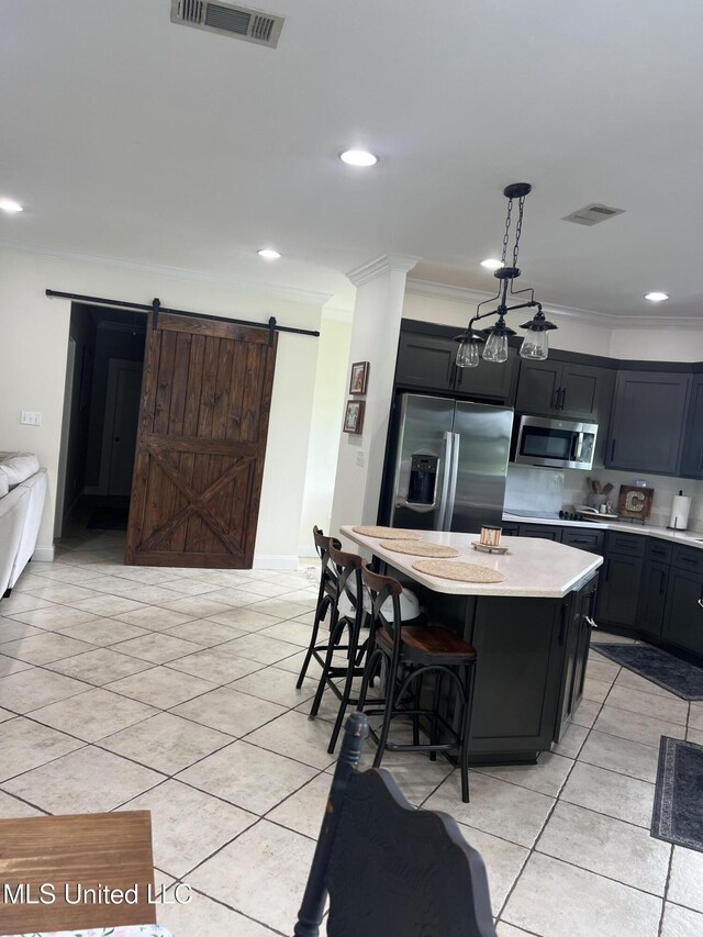 8100 Belle Etheridge Rd, Lucedale, MS 39452 - kitchen with stainless steel appliances, crown molding, light tile patterned floors, a kitchen island, and dark cabinetry