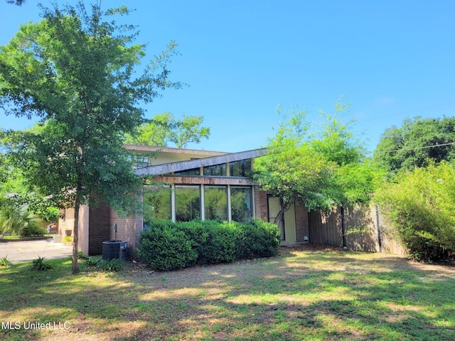 426 Donwood Pl, Biloxi, MS 39530 - back of property with central air condition unit, a lawn, and brick siding
