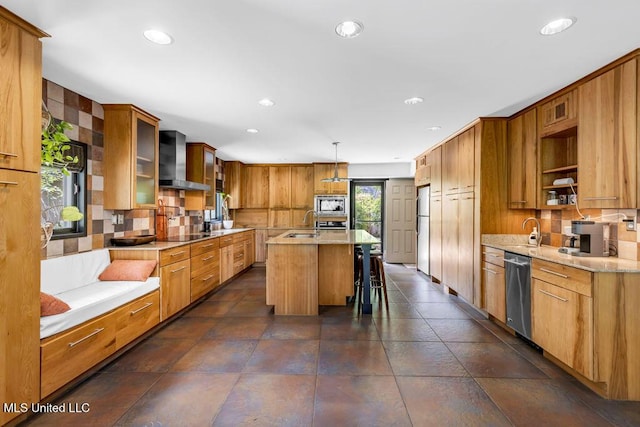 426 Donwood Pl, Biloxi, MS 39530 - kitchen featuring wall chimney exhaust hood, appliances with stainless steel finishes, decorative backsplash, recessed lighting, and a breakfast bar area