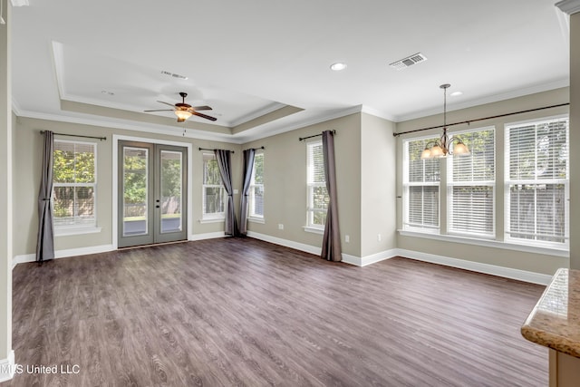 unfurnished living room with baseboards, visible vents, ornamental molding, and dark wood-type flooring