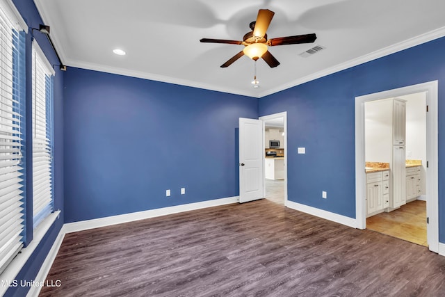 unfurnished bedroom with crown molding, baseboards, visible vents, and wood finished floors