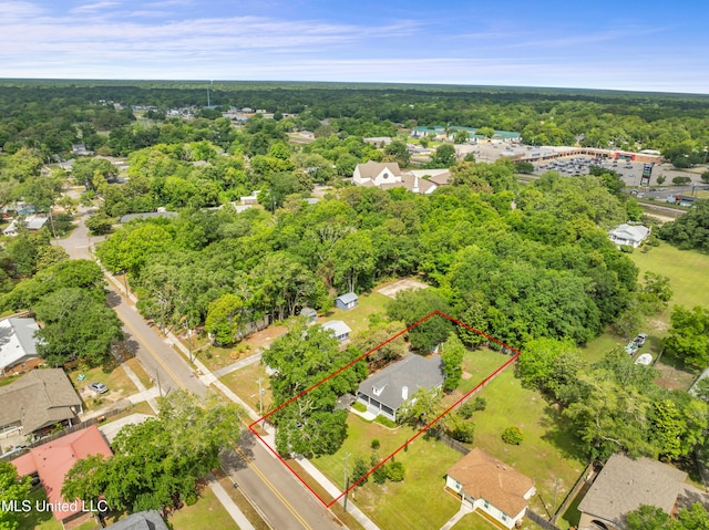 birds eye view of property featuring a view of trees