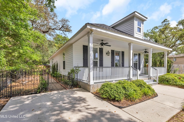 view of front of home with fence, a shingled roof, ceiling fan, and a porch