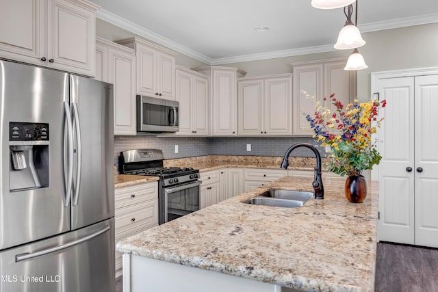 kitchen with light stone countertops, a center island with sink, a sink, backsplash, and stainless steel appliances
