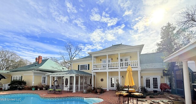 521 Holland Ave, Philadelphia, MS 39350 - rear view of house featuring a balcony, a patio, and french doors