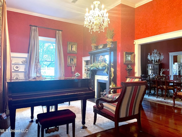 521 Holland Ave, Philadelphia, MS 39350 - miscellaneous room with hardwood / wood-style flooring, ornamental molding, and an inviting chandelier
