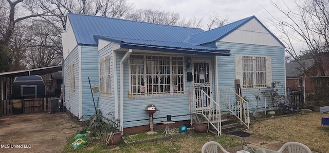 view of front of property with central AC and metal roof