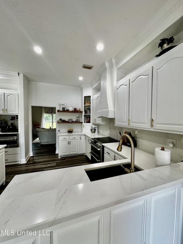 17500 Goff Farm Rd, Moss Point, MS 39562 - kitchen with double oven range, light stone counters, white cabinetry, and recessed lighting