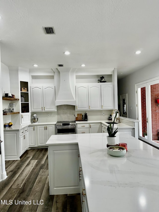 17500 Goff Farm Rd, Moss Point, MS 39562 - kitchen with electric stove, custom exhaust hood, white cabinetry, dark wood finished floors, and open shelves