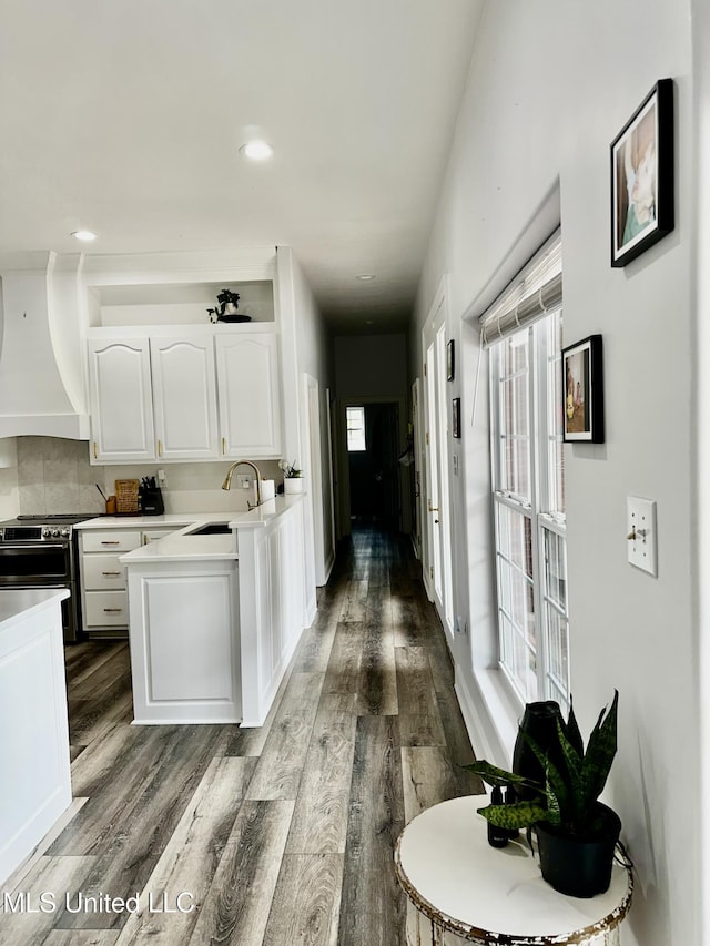 17500 Goff Farm Rd, Moss Point, MS 39562 - kitchen with stainless steel range, custom exhaust hood, white cabinetry, dark wood-type flooring, and recessed lighting