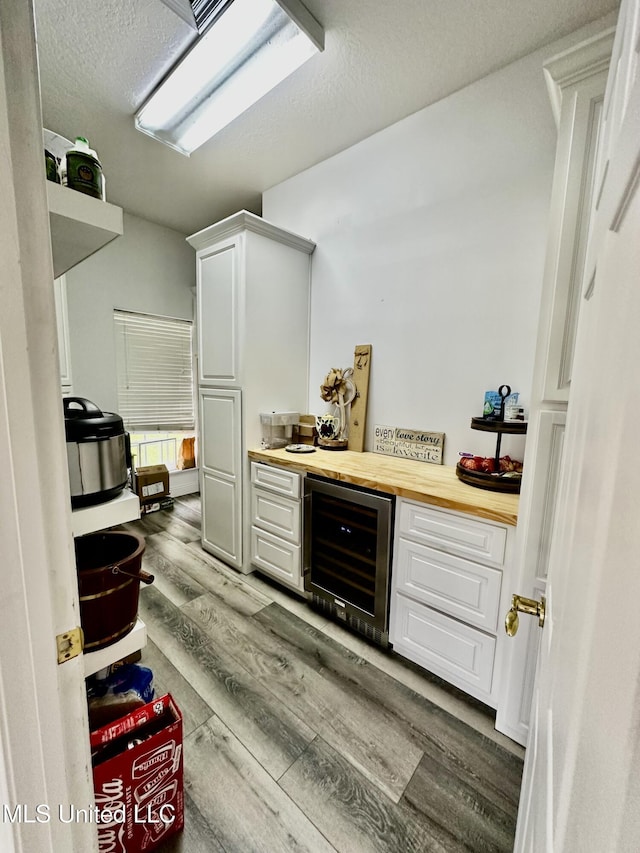 17500 Goff Farm Rd, Moss Point, MS 39562 - indoor dry bar with wine cooler, wood finished floors, and a textured ceiling