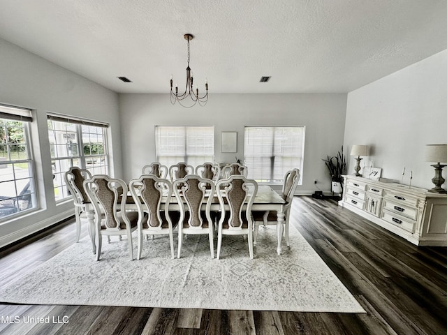 17500 Goff Farm Rd, Moss Point, MS 39562 - dining space featuring a chandelier, dark wood-style flooring, a textured ceiling, and baseboards