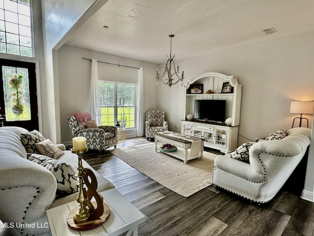 17500 Goff Farm Rd, Moss Point, MS 39562 - living room with a chandelier, dark wood-type flooring, and a textured ceiling