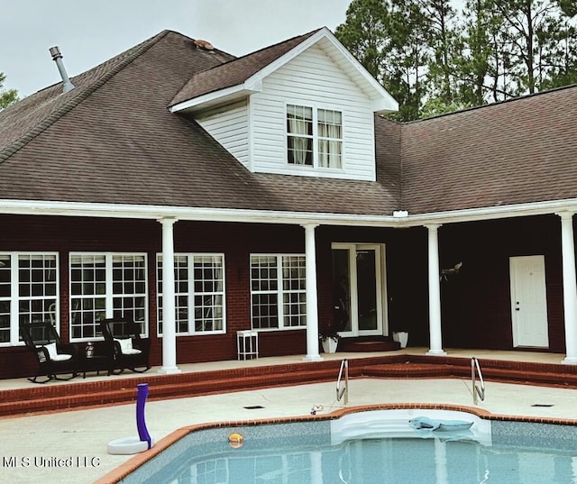 17500 Goff Farm Rd, Moss Point, MS 39562 - rear view of house with roof with shingles, a patio, and an outdoor pool