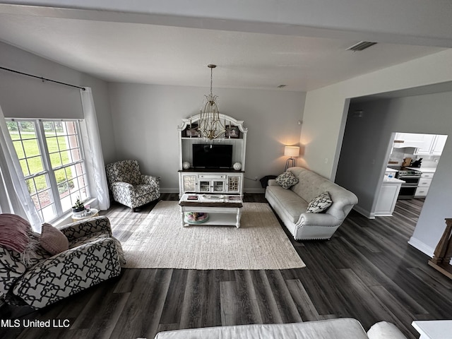 17500 Goff Farm Rd, Moss Point, MS 39562 - living room featuring a chandelier, dark wood-type flooring, and baseboards