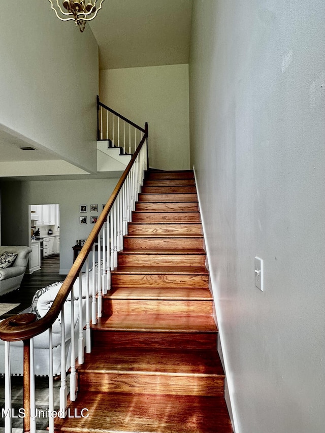 17500 Goff Farm Rd, Moss Point, MS 39562 - staircase featuring wood finished floors and a towering ceiling