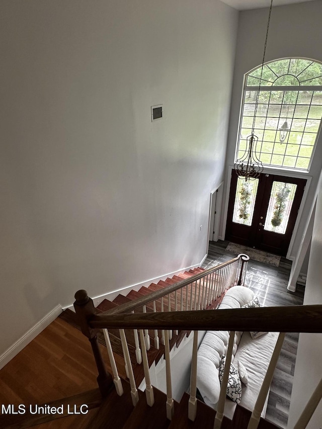 17500 Goff Farm Rd, Moss Point, MS 39562 - staircase featuring wood finished floors, baseboards, a chandelier, and a towering ceiling