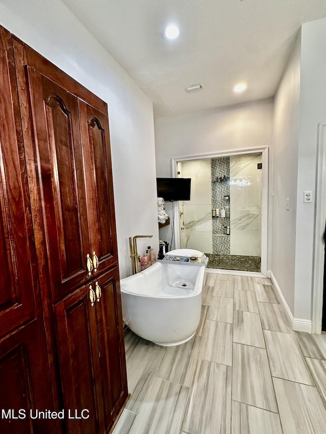 17500 Goff Farm Rd, Moss Point, MS 39562 - bathroom featuring a stall shower, a freestanding tub, and recessed lighting