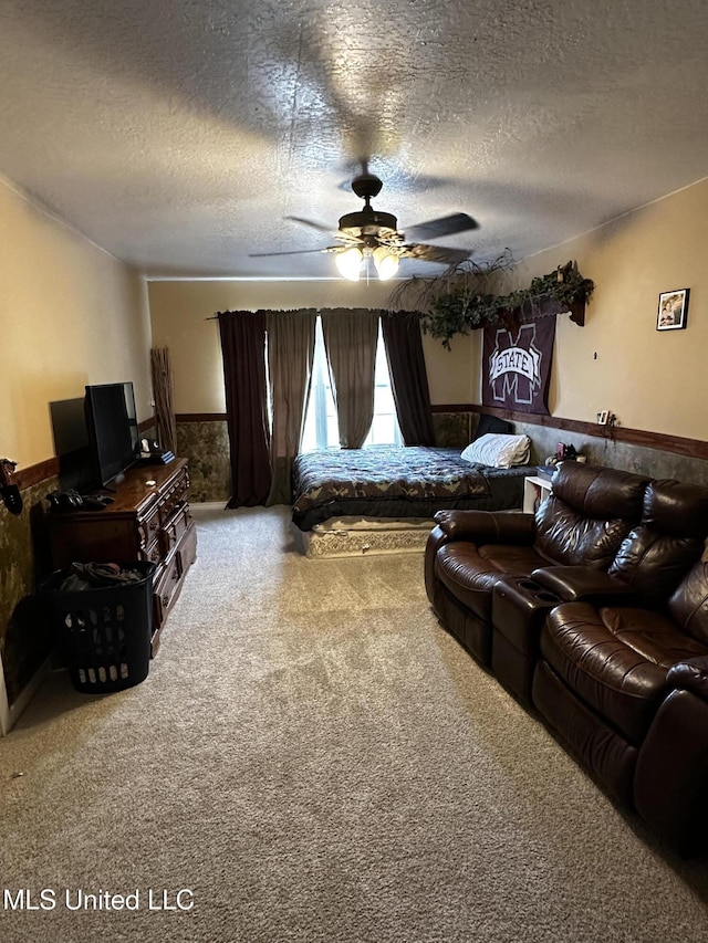 17500 Goff Farm Rd, Moss Point, MS 39562 - bedroom featuring a wainscoted wall, carpet, a textured ceiling, and a ceiling fan