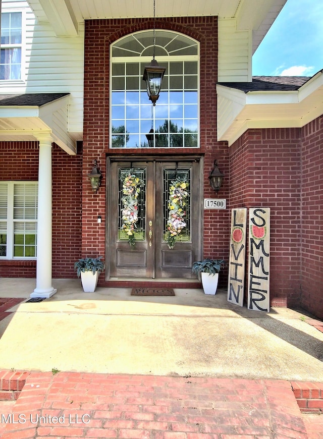 17500 Goff Farm Rd, Moss Point, MS 39562 - view of exterior entry with brick siding and french doors