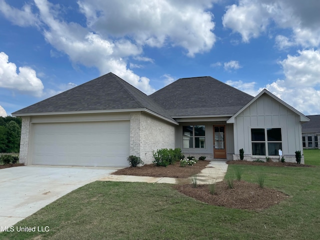 view of front of home with a garage and a front yard