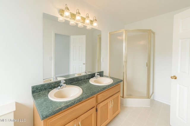 70 Yarbrough Loop, Holly Springs, MS 38635 - bathroom with a shower stall, double vanity, and tile patterned floors