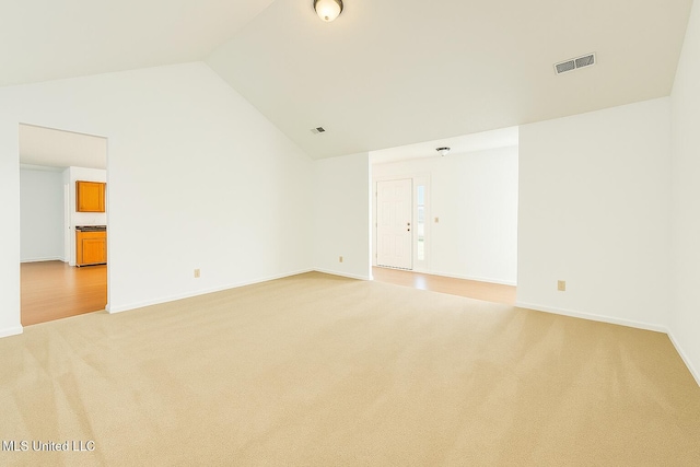 70 Yarbrough Loop, Holly Springs, MS 38635 - empty room featuring light colored carpet and high vaulted ceiling