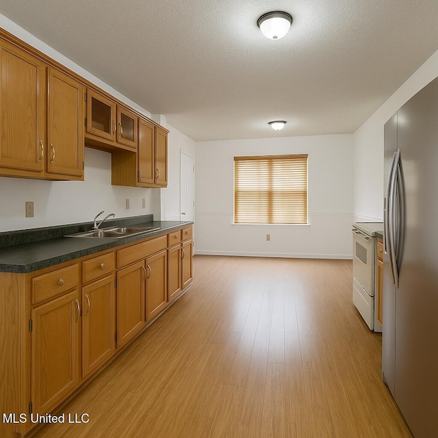 70 Yarbrough Loop, Holly Springs, MS 38635 - kitchen featuring stainless steel fridge with ice dispenser, white electric range, brown cabinetry, dark countertops, and a textured ceiling