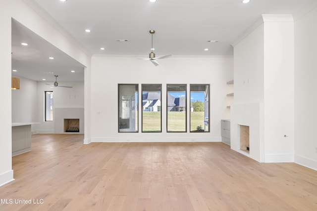 unfurnished living room featuring ceiling fan, light hardwood / wood-style floors, and ornamental molding