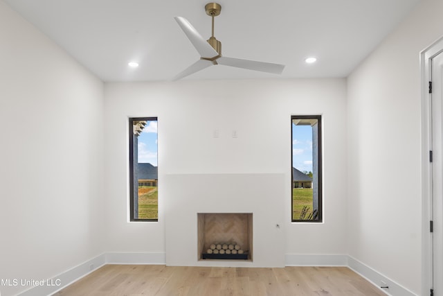 unfurnished living room featuring light hardwood / wood-style floors and ceiling fan