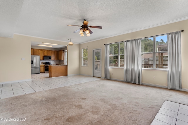 unfurnished living room featuring ornamental molding, light colored carpet, and plenty of natural light