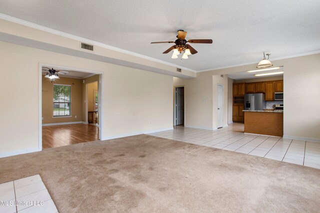 unfurnished living room with light carpet, ornamental molding, a textured ceiling, and ceiling fan