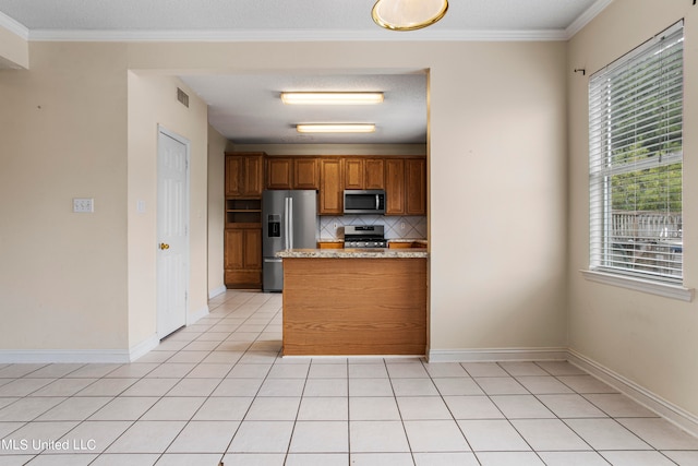 kitchen featuring stainless steel appliances, crown molding, light stone countertops, light tile patterned floors, and tasteful backsplash